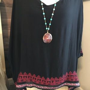 Black lined top with embroidered bottom